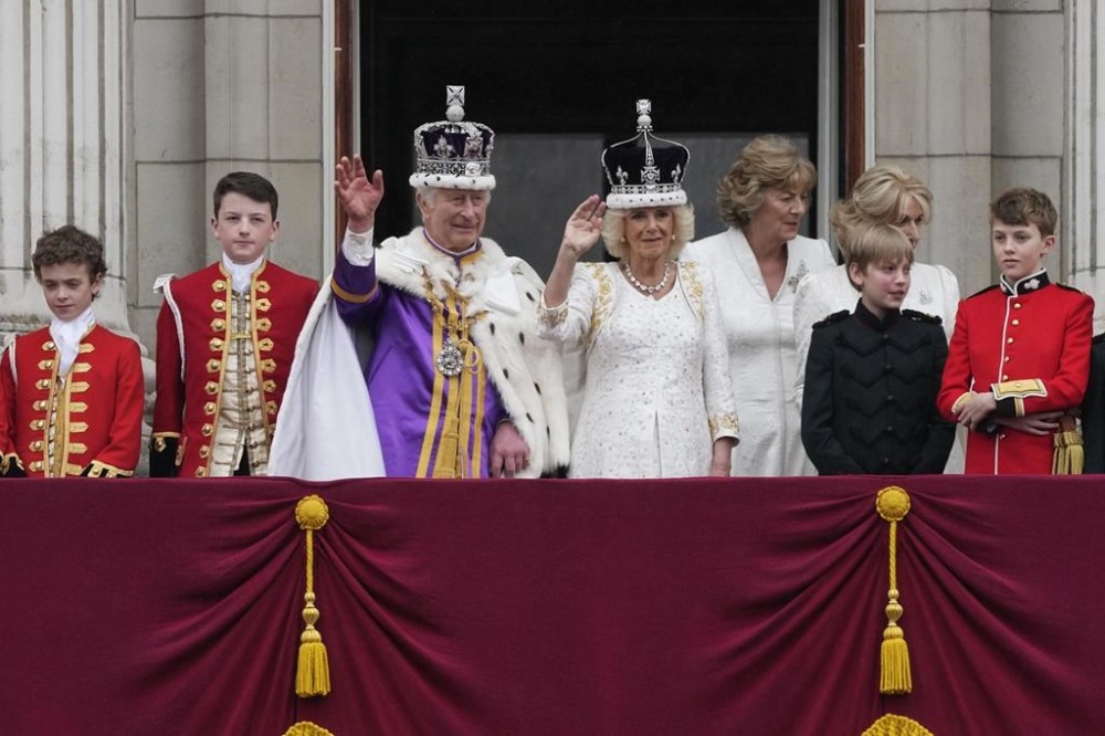 Britain's King Charles III and Queen Camilla wave to the crowds from the balcony of Buckingham Palace after the coronation ceremony in London, Saturday, May 6, 2023. (AP Photo/Frank Augstein)