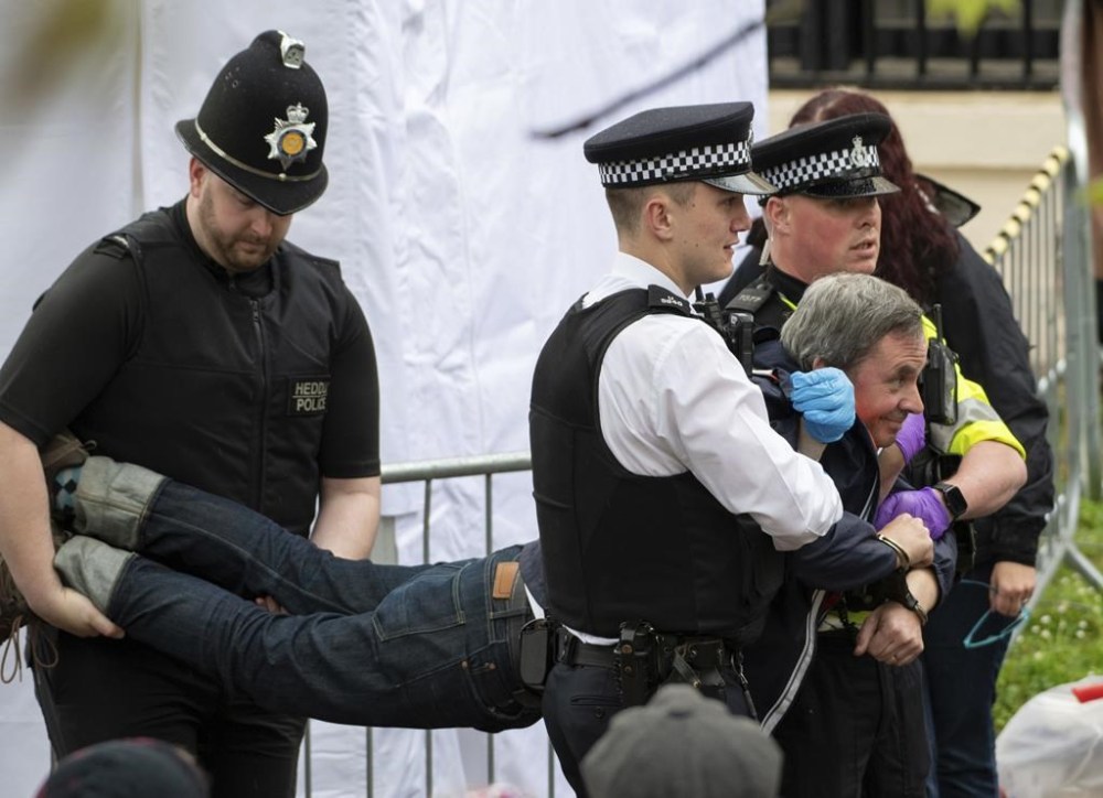 Police move in to crowd to detain 'Just Stop Oil' protestors before the King's Procession in London, Saturday, May 6, 2023. (Ian McIlgorm/Mail on Sunday via AP, Pool)