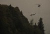 Helicopters with water buckets battle the Flood Falls Trail wildfire, in Hope, B.C., on Sept. 12, 2022. Three separate out-of-control wildfires burning near the boundary between British Columbia and Alberta, including two in the Peace River region, have prompted evacuation orders and an alert. THE CANADIAN PRESS/Darryl Dyck