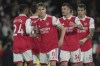 Arsenal's Martin Odegaard, centre, celebrates after the English Premier League soccer match between Arsenal and Chelsea at the Emirates Stadium in London, Tuesday, May 2, 2023. (AP Photo/Kin Cheung)