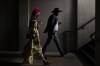People walk on the grounds of Churchill Downs before the 149th running of the Kentucky Derby horse race Saturday, May 6, 2023, in Louisville, Ky. (AP Photo/Charlie Riedel)