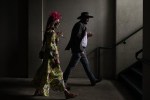 People walk on the grounds of Churchill Downs before the 149th running of the Kentucky Derby horse race Saturday, May 6, 2023, in Louisville, Ky. (AP Photo/Charlie Riedel)