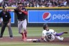 Washington Nationals second baseman Luis Garcia, second from left, turns the double play while avoiding Arizona Diamondbacks' Lourdes Gurriel Jr. (12) on a ball hit by Christian Walker in the third inning during a baseball game, Saturday, May 6, 2023, in Phoenix. (AP Photo/Rick Scuteri)