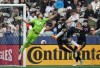 Vancouver Whitecaps' Ranko Veselinovic, second right, heads the ball wide of the goal behind Minnesota United goalkeeper Dayne St. Clair (97) as Kemar Lawrence (92) and Robin Lod, right, defend during the first half of an MLS soccer match in Vancouver, B.C., Saturday, May 6, 2023. THE CANADIAN PRESS/Darryl Dyck