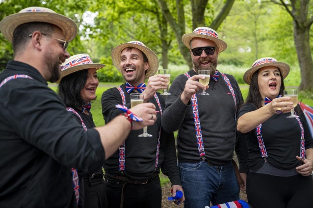 People cheer for Britain's King Charles III and Queen Camilla during the Big Lunch celebrations in London's Regent's Park, Sunday, May 7, 2023. The Big Lunch is part of the weekend of celebrations for the Coronation of King Charles III. (AP Photo/Vadim Ghirda)