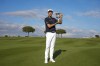 Adrian Meronk holds the trophy after winning the final round of the Italian Open golf tournament in Guidonia, Montecelio, Sunday, May 7, 2023. The Marco Simone club outside Rome will host the Ryder Cup later this year. (AP Photo/Andrew Medichini)