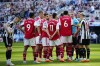 Arsenal and Newcastle players surround the referee during a penalty incident that finally was not given during an English Premier League soccer match between Newcastle and Arsenal at St James' Park stadium in Newcastle, Sunday, May 7, 2023. (AP Photo/Jon Super)
