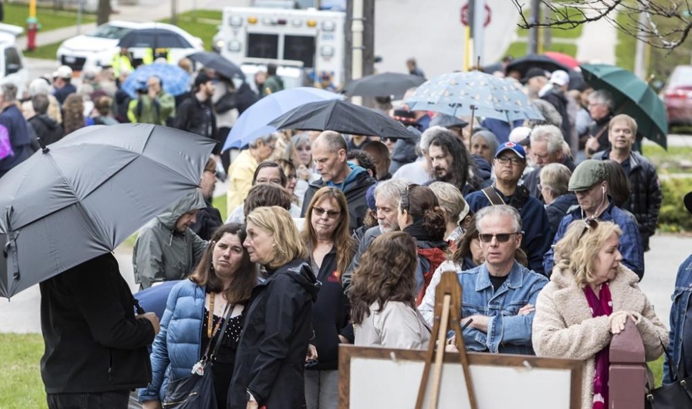 Members of the public line up to pay their respects at visitation for singer-songwriter Gordon Lightfoot at St. Paul's United Church, in his hometown of Orillia, Ont., Sunday, May 7, 2023. The legendary Canadian artist died May 1, at the age of 84 from natural causes. THE CANADIAN PRESS/Fred Thornhill