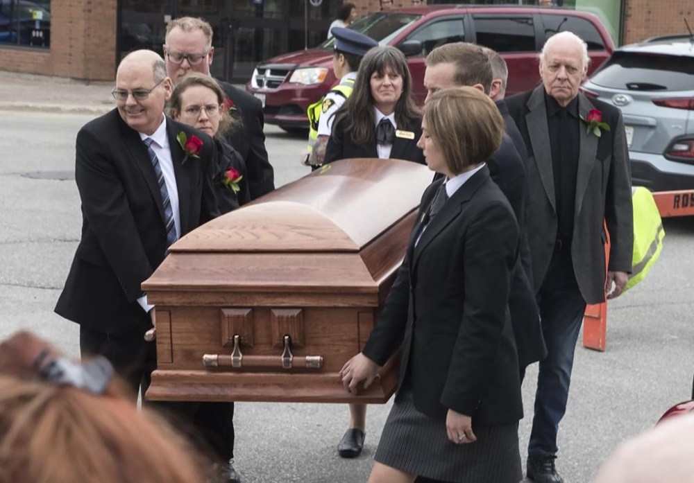 Family members carry the casket of Gordon Lightfoot into St. Paul's United Church, in his hometown of Orillia, Ont., Sunday, May 7, 2023. The folk singer-songwriter died May 1 at the age of 84. THE CANADIAN PRESS/Fred Thornhill