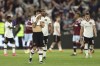 Manchester United's Bruno Fernandes, centre, reacts disappointed after the English Premier League soccer match between West Ham United and Manchester United at the London Stadium in London, England, Sunday, May 7, 2023. (AP Photo/Ian Walton)