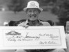 FILE - Don January sits in a rocking chair to display his winnings of $26,000 earned for his 16th Senior PGA victory, in the Middlesex Golf Classic in Concord, Mass., on Sept. 23, 1984. The PGA Tour said January, who won the 1967 PGA Championship, died Sunday, May 7, 2023, at age 93. (AP Photo/Sean Kardon, File)