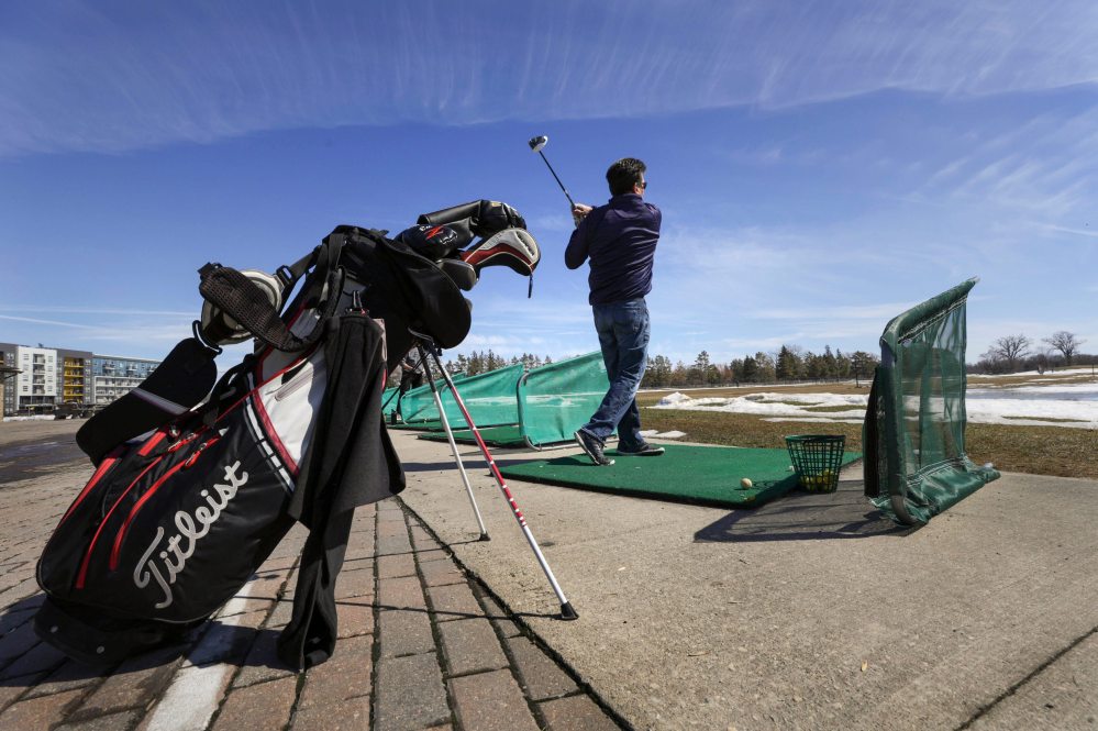 RUTH BONNEVILLE / WINNIPEG FREE PRESS Big swings were had by all at Shooters Family Golf Centre Tuesday morning.