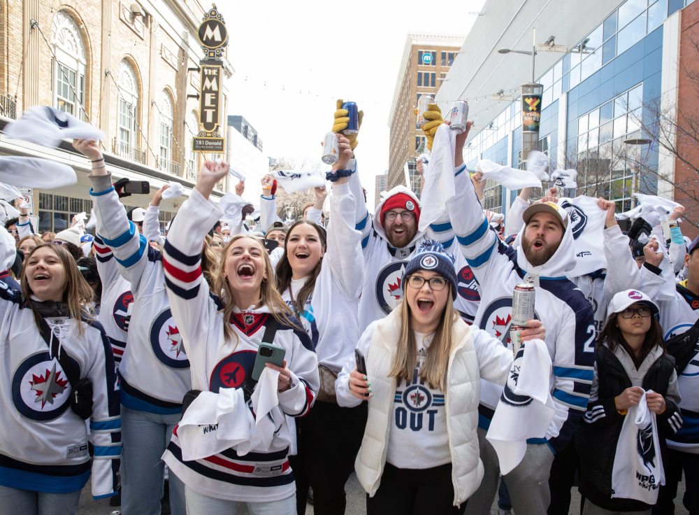 JESSICA LEE / WINNIPEG FREE PRESS
From left: Clara Sydor, Breanna Dennis, Nikki Slywchuk (second row), Nathan Powell (in red hat), Emily Riesz and Ronald Johnson (second row) cheer for the Winnipeg Jets at a Whiteout party. Thousands of Winnipeg Jets fans gather downtown beside Canada Life Centre April 22, 2023 to watch the Jets play against the Golden Knights at a Whiteout party.