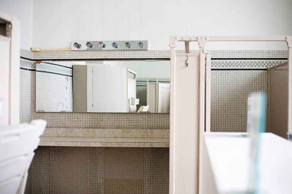 The bathrooms and original tile on the fourth floor.