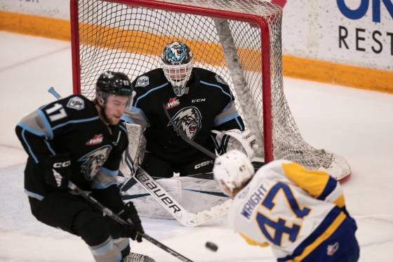 Winnipeg Ice goaltender Daniel Hauser keeps an eye on the puck Saturday as Saskatoon Blades defenceman Charlie Wright takes a shot on goal. (Brook Jones / Winnipeg Free press files)