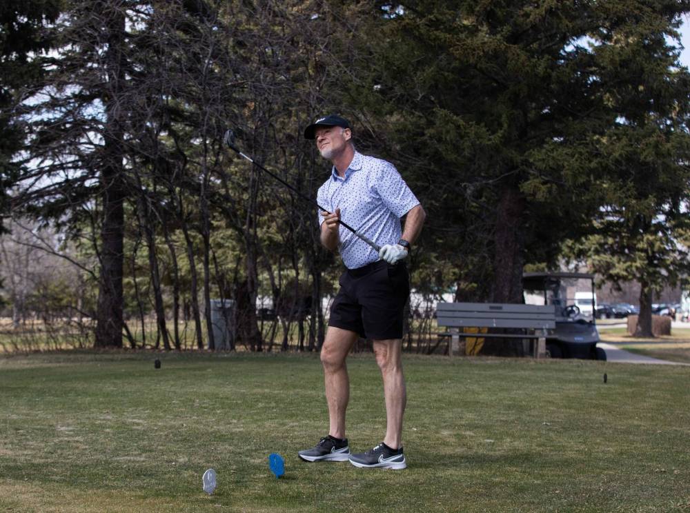 Duane Penner observes where the ball he just hit lands at Pine Ridge Golf Club on May 5. (Jessica Lee / Winnipeg Free Press files)