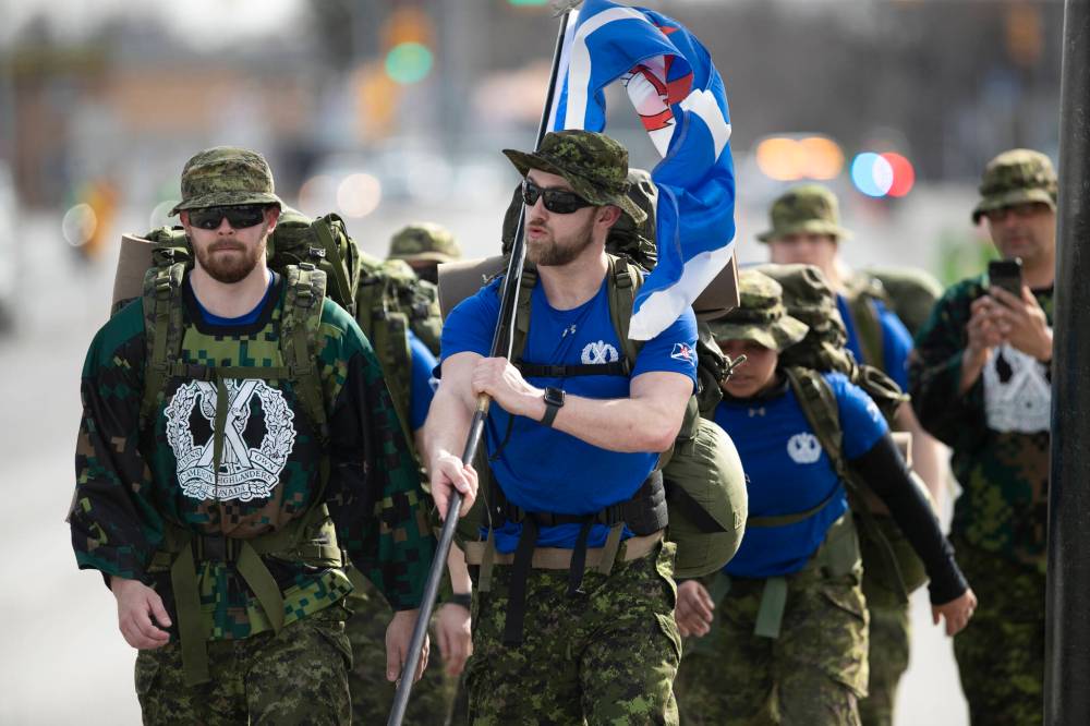 BROOK JONES / WINNIPEG FREE PRESS
                                Members of the Queen’s Own Cameron Highlanders of Canada walk down Portage Avenue as they reach the halfway mark in the marathon. The Queen’s Own Cameron Highlanders of Canada is the oldest highland regiment in Western Canada.