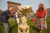 Mike Deal / Winnipeg Free Press (From left) David Pensato, Executive Director, The Exchange District BIZ, Joe Kornelsen, Executive Director at West End BIZ, and Kate Fenske, CEO, Downtown Winnipeg BIZ, play a game of oversized Jenga during a media event at Old Market Square, where the three downtown Business Improvement Zones – Downtown Winnipeg BIZ, The Exchange District BIZ, and West End Biz, were kicking off Back Downtown Spirit Week, a week-long event to celebrate downtown Winnipeg and its community. 230515 - Monday, May 15, 2023.