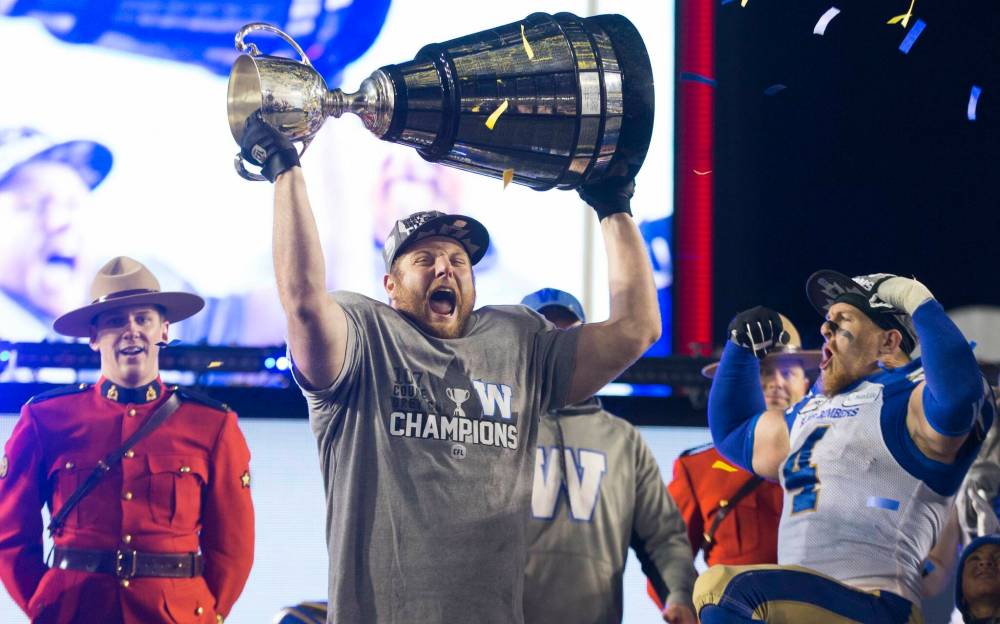 Todd Korol / THE CANADIAN PRESS files
Jake Thomas (left), seen here celebrating the Blue Bombers, 2019 Grey Cup victory with Adam Bighill, recently celebrated the birth of his daughter, Avery.