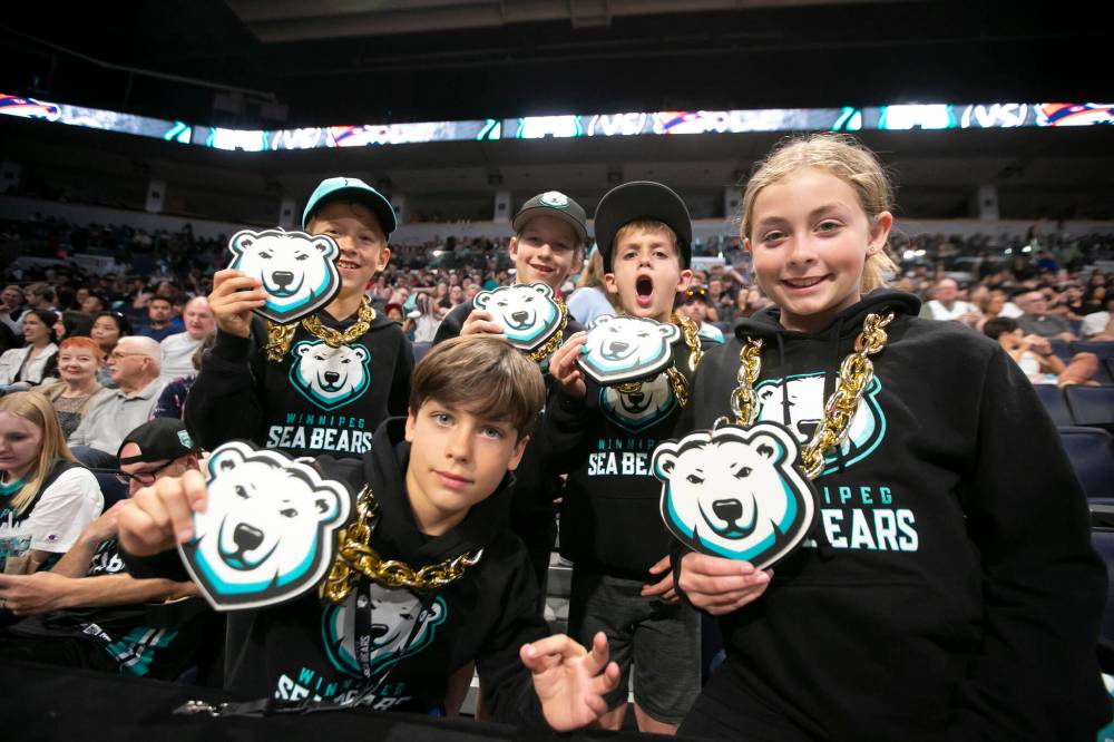 BROOK JONES / WINNIPEG FREE PRESS
Dane Stewart (far left), and his brother, Parker (second from far right) with friends Cole Bergmann (second from far left) and his brother Emmett (middle) and sister, Brooklyn (far right) were excited for the game and showed off some merchandise featuring the team's logo.