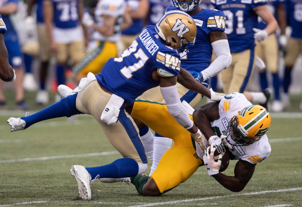 JASON FRANSON / THE CANADIAN PRESS
Winnipeg Blue Bombers’ Brandon Alexander (37) tackles Edmonton Elks’ Sammie Coates (89) during the first half.