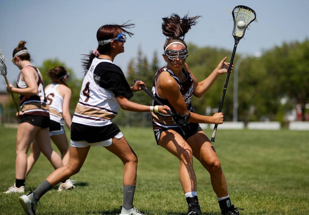 JOHN WOODS / WINNIPEG FREE PRESS
                                Playing lacrosse for only the second time, Laylah Laquette-Koch (left) defends against Payton Cvetkovic during the inaugural female lacrosse day at Shaughnessy Park on Sunday.