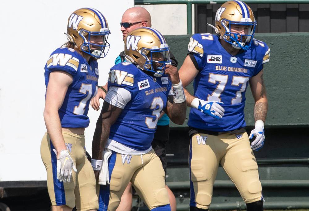 Jason Franson / THE CANADIAN PRESS
Blue Bombers quarterback hopeful Tyrrell Pigrome (centre) scampered for a 45-yard touchdown Saturday in CFL pre-season action against the Elks in Edmonton.