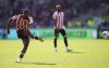 Brentford's Ivan Toney scores his sides first goal from a free kick during the English Premier League soccer match between Brentford and Nottingham Forest at the Gtech Community Stadium, London, Saturday, April 29, 2023. (Nick Potts/PA via AP)