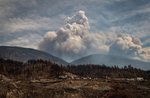 Two out-of-control wildfires in northeastern British Columbia have nearly doubled in size in one day. A pyrocumulus cloud, also known as a fire cloud, rises in the mountains above Lytton, B.C., on Sunday, Aug.15, 2021. THE CANADIAN PRESS/Darryl Dyck