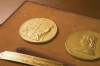 FILE - This undated photo shows the front and back sides of the medal awarded for the Pulitzer Prizes in New York. The Pulitzer Prizes recognizing the best of journalism and the arts in 2022 were announced Monday. (The Pulitzer Prizes via AP)
