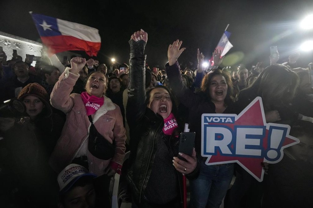 Republican party members celebrate obtaining the largest number of representatives after the election for the Constitutional Council, which will draft a new constitution proposal in Santiago, Chile, Sunday, May 7, 2023. A first attempt to replace the current Charter bequeathed by the military 42 years ago was rejected by voters during a referendum in 2022. (AP Photo/Esteban Felix)