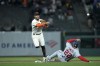 San Francisco Giants shortstop Thairo Estrada, left, throws to first after forcing out Washington Nationals' Dominic Smith at second during the eighth inning of a baseball game in San Francisco, Monday, May 8, 2023. Nationals' CJ Abrams reached first on the play. (AP Photo/Godofredo A. Vásquez)
