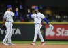 Texas Rangers second baseman Marcus Semien, left, greets right fielder Adolis Garcia as they celebrate a win over the Seattle Mariners in a baseball game Monday, May 8, 2023, in Seattle. (AP Photo/Lindsey Wasson)