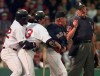 FILE - In this June 3, 1998, file photo, Boston Red Sox manager Jimy Williams, second from right, gets between home plate umpire Tim Welke, right, and batter John Valentin, while teammate Mo Vaugh restrains Valentin, who was arguing two called strikes from Baltimore Orioles pitcher Doug Johns in the fourth inning of a baseball game at Fenway Park in Boston. Valentin and Williams were ejected from the game. Automatic balls and strikes could soon be coming to the major leagues. Disappearing with that are the complaints that an umpire’s strike zone was too wide or a pitcher was getting squeezed, followed by the helmet-slamming, dirt-kicking dustups that are practically as old as the sport itself. (AP Photo/Charles Krupa, File)