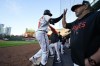 Baltimore Orioles' Adley Rutschman, left, is greeted by manager Brandon Hyde, right, and bench coach Fredi Gonzalez, center, after hitting a two-run home run off Tampa Bay Rays starting pitcher Zach Eflin during the third inning of a baseball game, Tuesday, May 9, 2023, in Baltimore. Orioles' Cedric Mullins scored on the home run. (AP Photo/Julio Cortez)