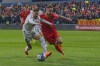 FILE - Montenegro's Marko Vesovic, right, duels for the ball with Serbia's Filip Mladenovic during the Euro 2024 group G qualifying soccer match between Montenegro and Serbia at the City stadium in Podgorica, Montenegro, Monday, March 27, 2023. UEFA has ordered Serbia to host a European Championship qualifier in an empty stadium because of discriminatory chants by fans at a game against neighboring Montenegro. Fans traded ethnic-based slurs at Serbia’s 2-0 win in Podgorica in March. UEFA also sanctioned the Montenegrin soccer federation for discriminatory behavior. (AP Photo/Risto Bozovic, File)