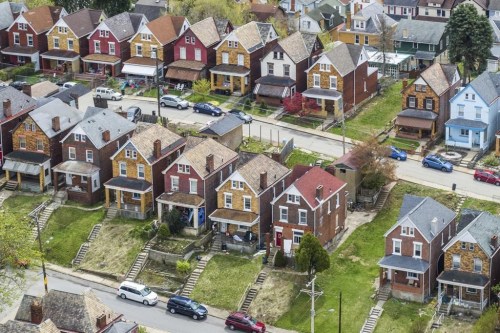 FILE - This April 12, 2021 photo shows houses in Knoxville, a neighborhood in Pittsburgh. Most older adults ages 50 to 80 say it’s important to stay in their homes for as long as they can, according to the 2022 National Poll on Healthy Aging from the University of Michigan. But aging in place isn’t as simple as just staying home — you must consider the costs, including those for age-related home renovations, home maintenance and caregiving. (Andrew Rush/Pittsburgh Post-Gazette via AP, File)