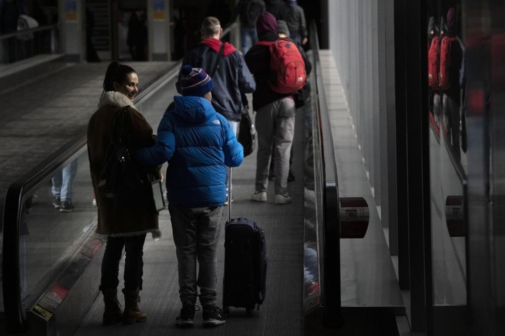 People make their way through Pearson Airport in Mississauga, Ont., on Tuesday, March 14, 2023. A new survey ranks Canada’s two biggest airlines below the average for customer satisfaction among major North American carriers. THE CANADIAN PRESS/Chris Young