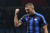 Inter Milan's Edin Dzeko celebrates after scoring his side's opening goal during the Champions League semifinal first leg soccer match between AC Milan and Inter Milan at the San Siro stadium in Milan, Italy, Wednesday, May 10, 2023. (AP Photo/Antonio Calanni)