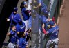 Texas Rangers' Robbie Grossman is greeted in the dugout after scoring on a double by Nathaniel Lowe during the third inning of a baseball game against the Seattle Mariners, Wednesday, May 10, 2023, in Seattle. (AP Photo/Lindsey Wasson)