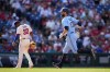 Toronto Blue Jays' Brandon Belt, right, rounds the bases past Philadelphia Phillies third baseman Edmundo Sosa after hitting a home run during the fourth inning of a baseball game, Wednesday, May 10, 2023, in Philadelphia. (AP Photo/Matt Slocum)