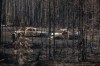 Burnt out trucks from a wildfire sit on a property near Drayton Valley, Alta., Wednesday, May 10, 2023. Indigenous Services Canada says wildfires are threatening nine First Nations in Alberta, including the Little Red River Cree Nation, where more than 100 structures have been lost in the community of Fox Creek. THE CANADIAN PRESS/Jason Franson.
