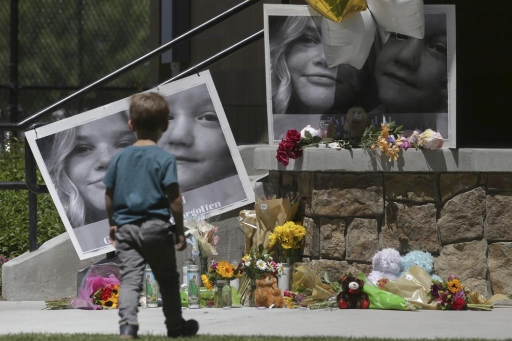 FILE - A boy looks at a memorial for Tylee Ryan and Joshua
