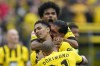 Dortmund's Karim Adeyemi, up, Jude Bellingham, left, Emre Can, right, and Donyell Malen, celebrate a goal by Bellingham during the German Bundesliga soccer match between Borussia Dortmund and VfL Wolfsburg in Dortmund, Germany, Saturday, May 7, 2023. (AP Photo/Martin Meissner)