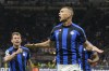 Inter Milan's Edin Dzeko, right, celebrates after scoring his side's opening goal during the Champions League semifinal first leg soccer match between AC Milan and Inter Milan at the San Siro stadium in Milan, Italy, Wednesday, May 10, 2023. (AP Photo/Antonio Calanni)