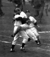 FILE - New York Yankees catcher Yogi Berra is embraced by pitcher Don Larsen as he leaps into Larsen's arms at the end of Game 5 of baseball's World Series against the Brooklyn Dodgers at New York's Yankee Stadium, Oct. 8, 1956. Larsen pitched a perfect game. “It Ain’t Over,” a 98-minute documentary on Yogi Berra's life, aims to elevate his playing career alongside his status as a cultural icon. The Sony Pictures Classics film opens Friday, May 12, 2023, in theaters in the New York tri-state area and Los Angeles following its premiere last June at the Tribeca Festival. (AP Photo, File)
