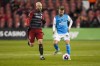 Toronto FC midfielder Michael Bradley (4) battles for the ball against Charlotte FC midfielder Chris Hegardt (19) during second half MLS soccer action in Toronto, on Saturday, April 1, 2023. TFC coach Bob&nbsp;Bradley revealed Thursday that captain Michael Bradley, his son, was scheduled to leave for England later Thursday to undergo a procedure Saturday in London on his hamstring. THE&nbsp;CANADIAN PRESS/Andrew Lahodynskyj