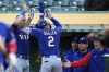 Texas Rangers' Marcus Semien, center, celebrates with teammates at the dugout after hitting a solo home run against the Oakland Athletics during the sixth inning of a baseball game in Oakland, Calif., Thursday, May 11, 2023. (AP Photo/Godofredo A. Vásquez)