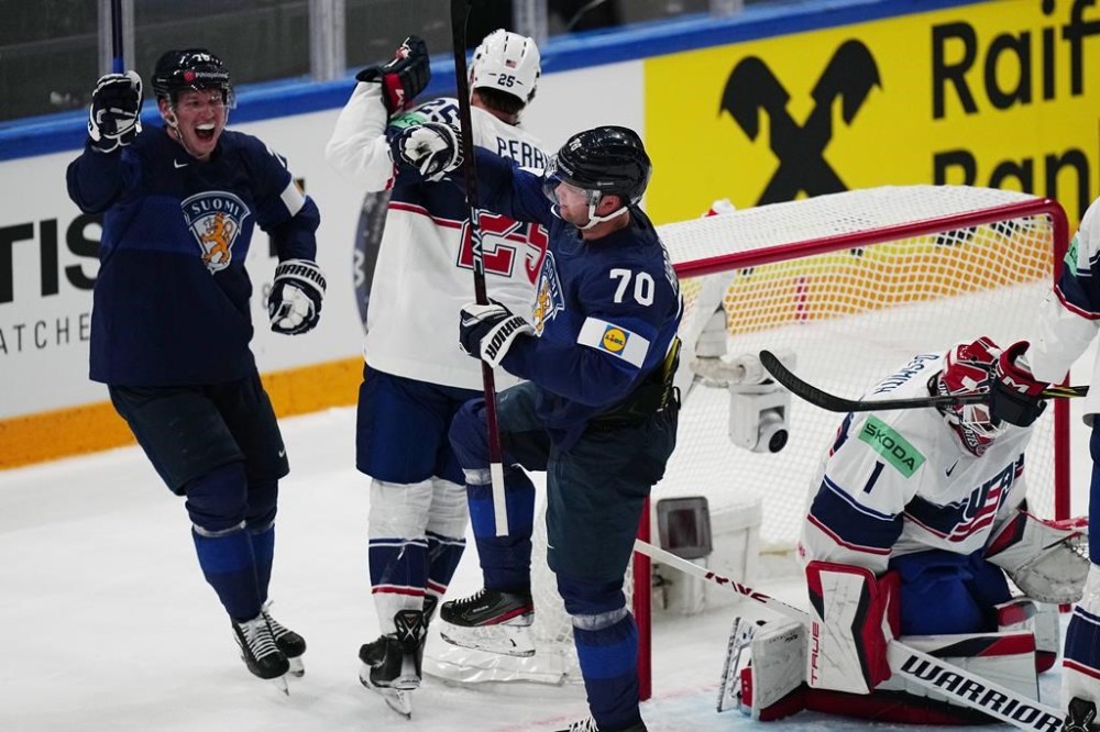 Finland's Teemu Hartikainen, centre, celebrates after scoring the opening goal during the group A match between Finland and USA at the ice hockey world championship in Tampere, Finland, Friday, May 12, 2023. (AP Photo/Pavel Golovkin)