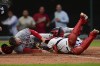 Los Angeles Angels' Brandon Drury, left, scores as Cleveland Guardians catcher Cam Gallagher is late with the tag during the fourth inning of a baseball game Friday, May 12, 2023, in Cleveland. (AP Photo/David Dermer)